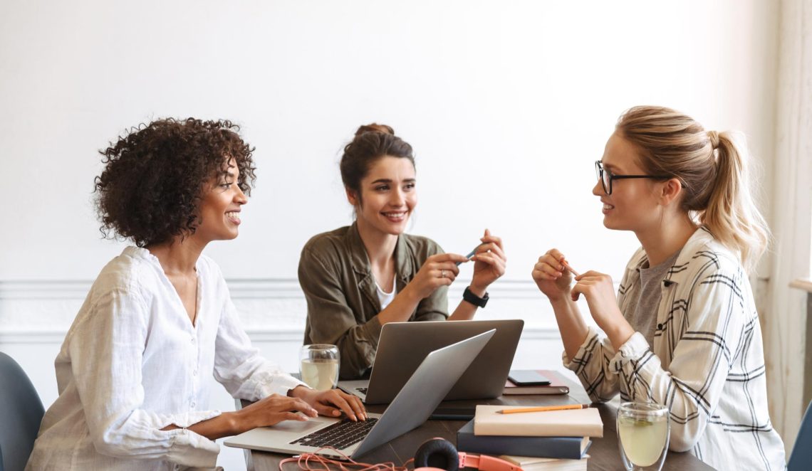 group-of-cheerful-young-women-studying-together-AHK5QF2.jpg